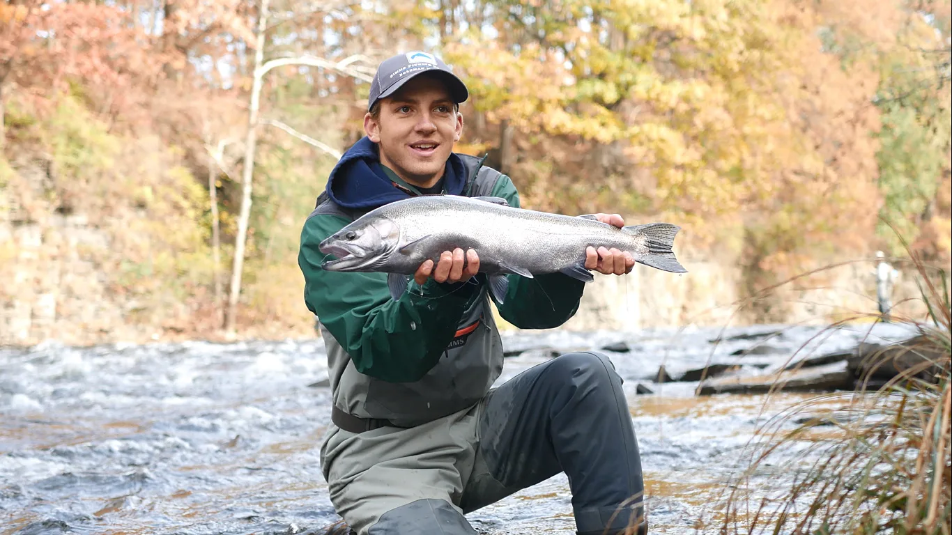 Angler holding up steelhead