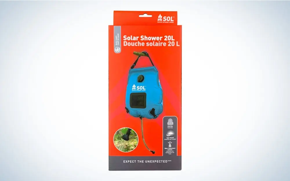 The orange package for an SOL solar shower on a black and white gradient background.