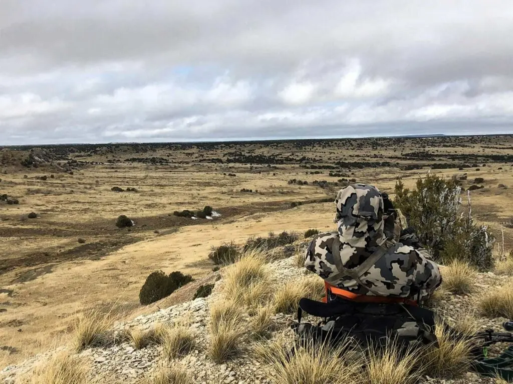 hunter on the hills scouting for elk