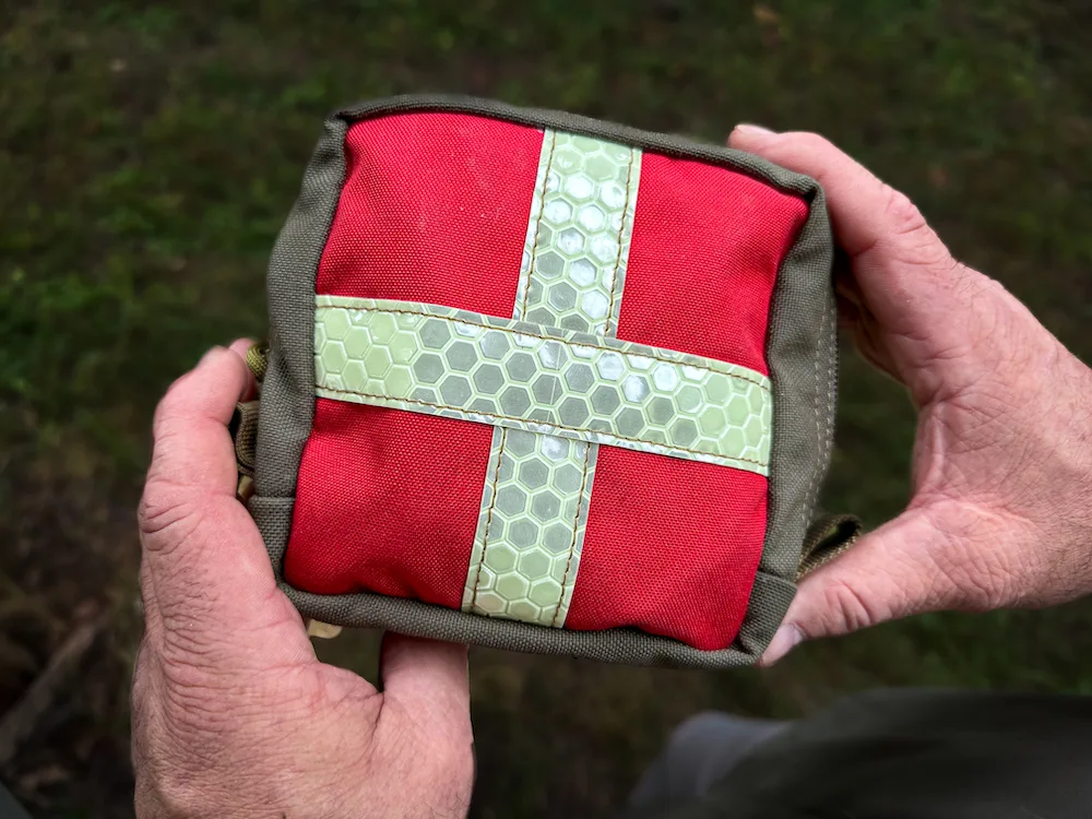 Close-up of man's hands holding Tuff Possum Med Pouch