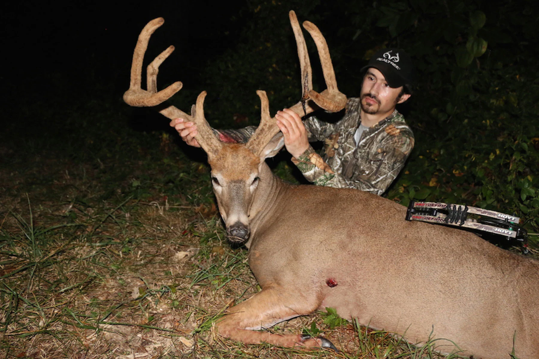 A hunter poses with a whitetail buck i full velvet. 