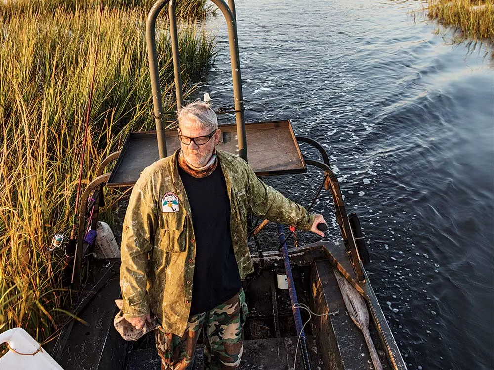 guide navigating marshes in a john boat