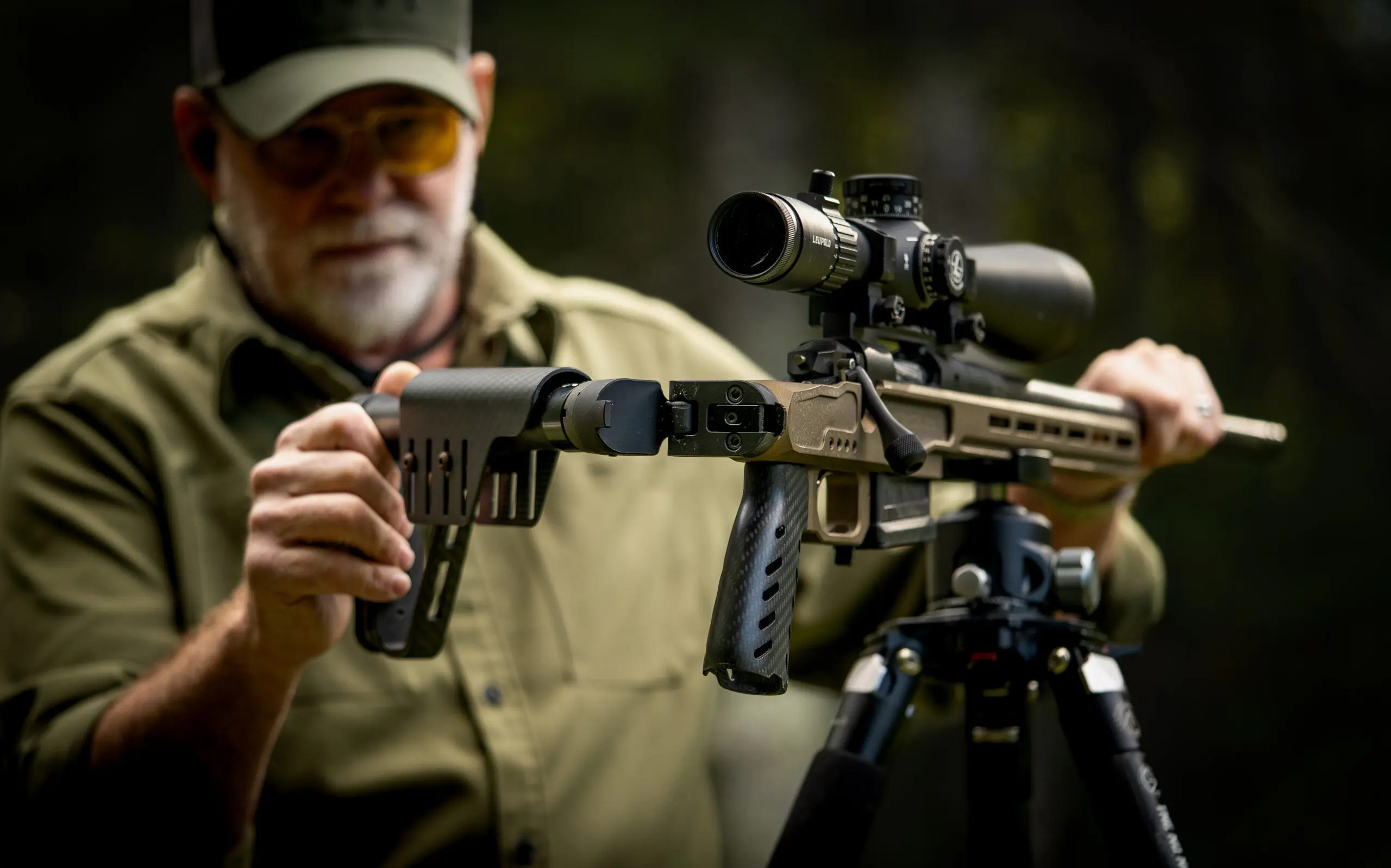 Man folding the stock on a rifle.