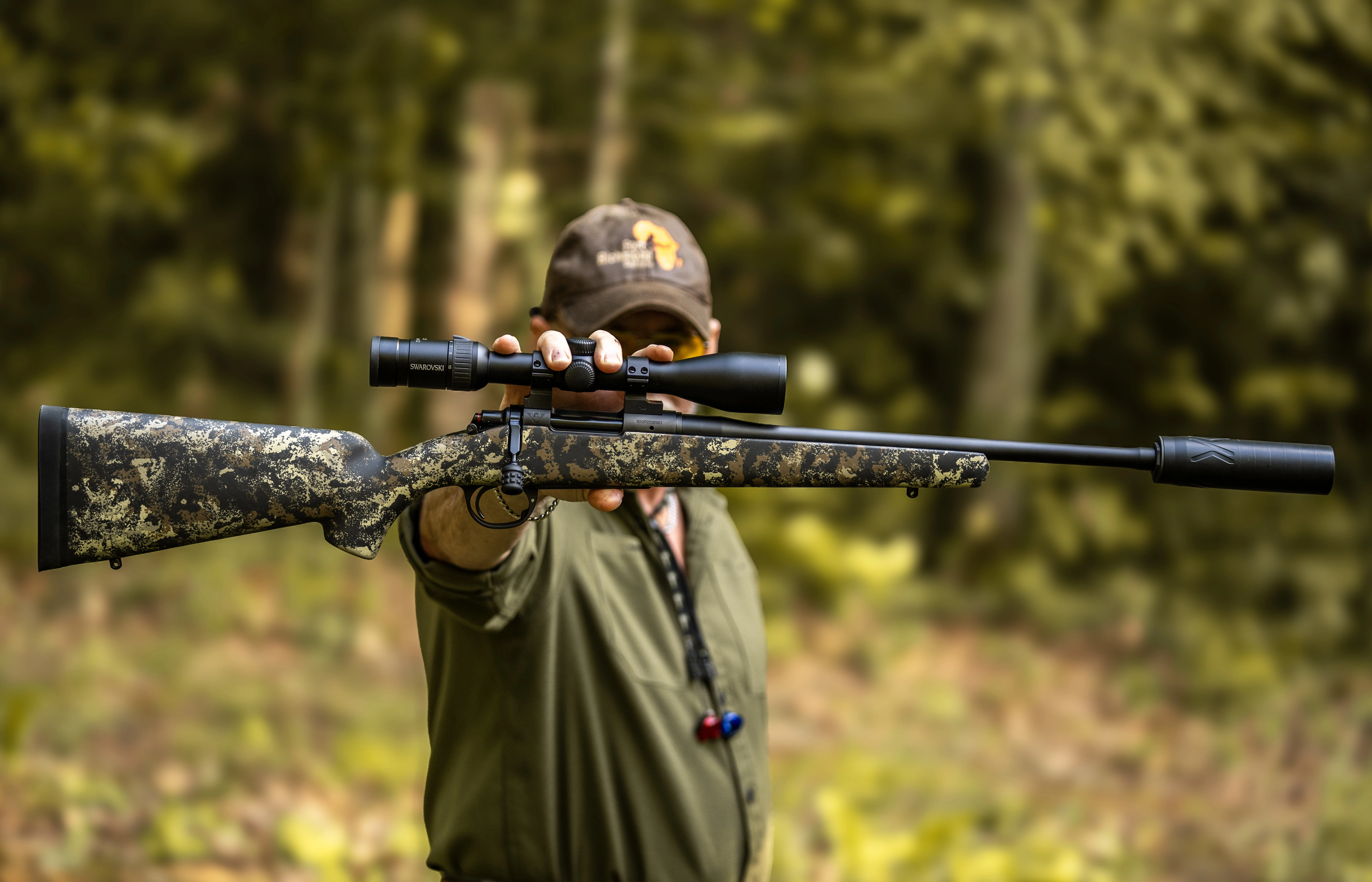 Shooter holding the new Wilson Combat Model 20S rifle at arm length in woods. 