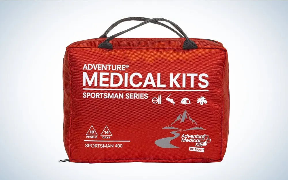 An Adventure Medical First Aid kit on a black and white gradient background.