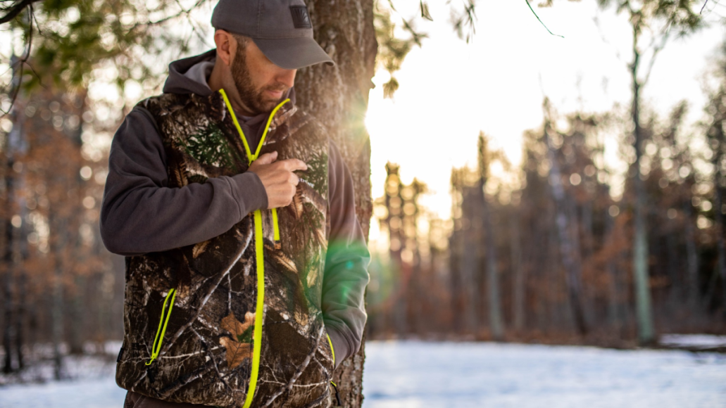 Hunter wearing Tidewe heated vest in the woods