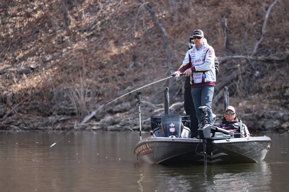 Angler making a cast on bass boat