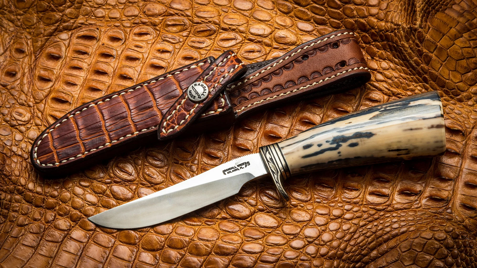 A vintage Randall Model 7 knife and sheath on a crocodile leather. 