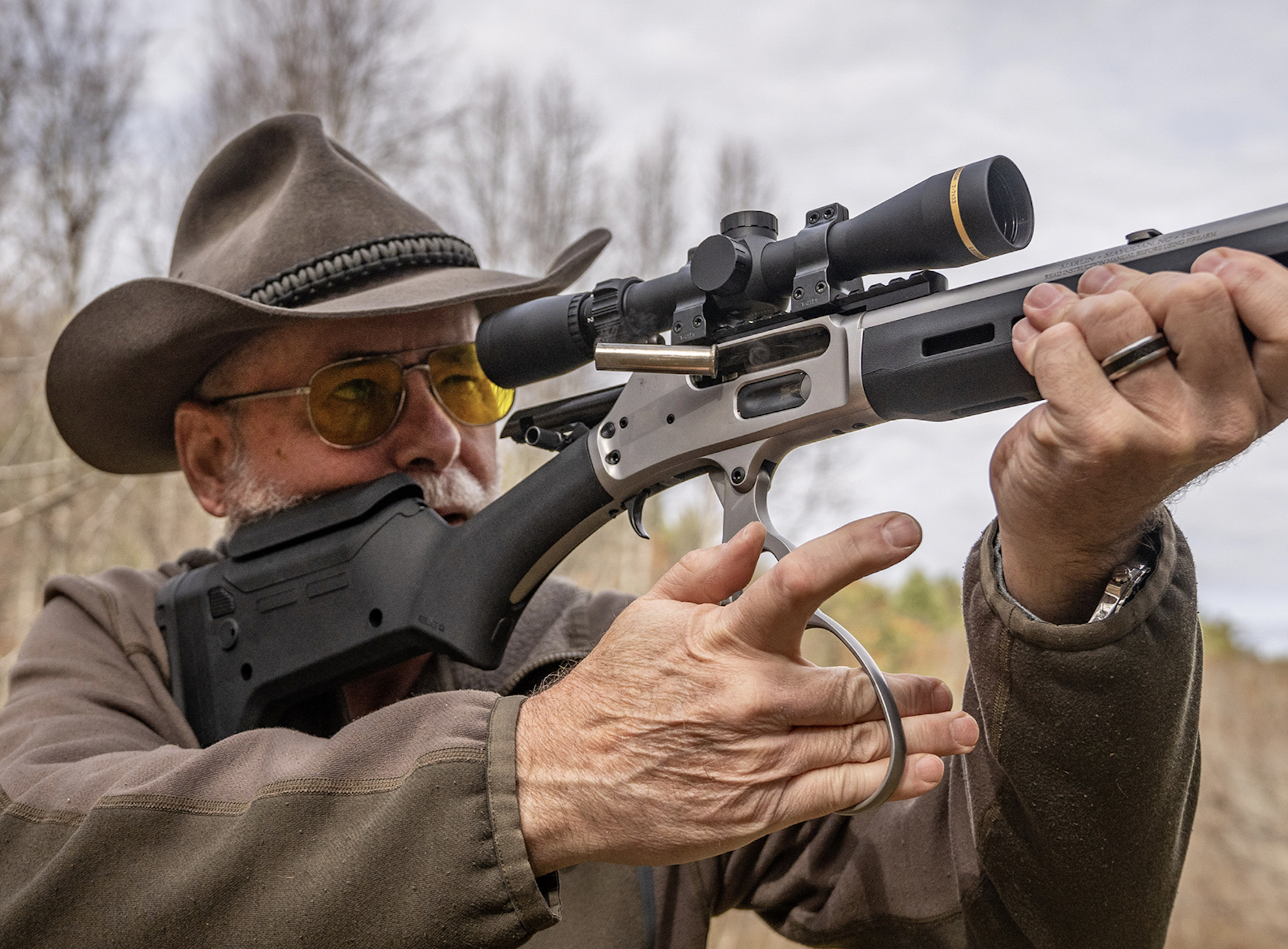 A shooter works the action of a lever-action rifle.