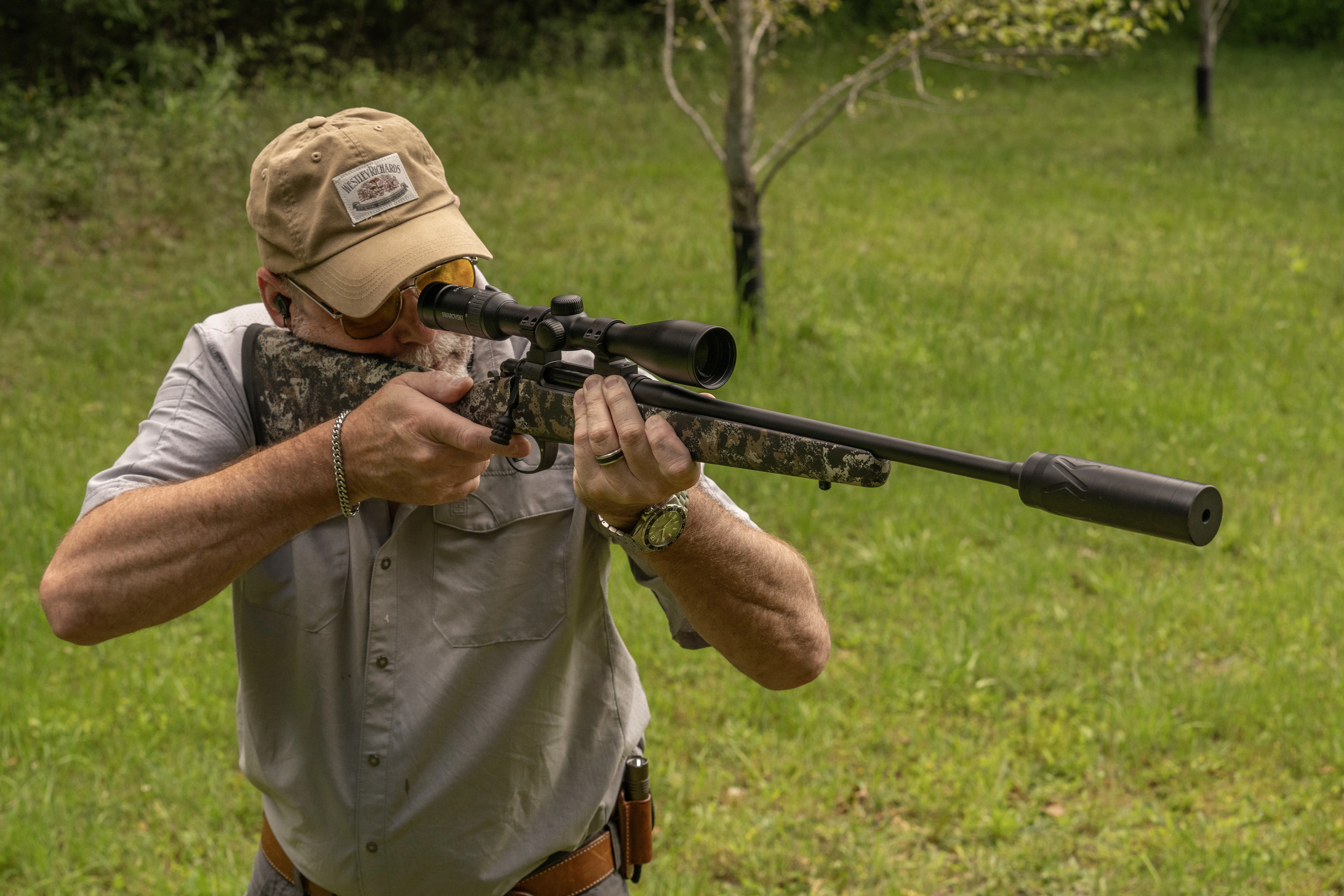 A shooter fires the Wilson Combat Model 20S with suppressor from the offhand position.