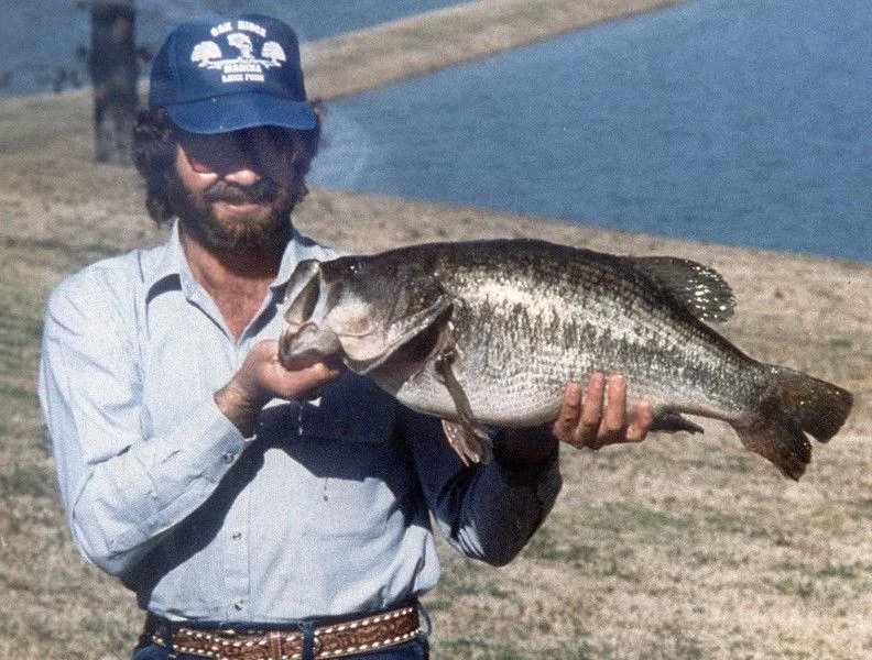 An angler poses with the Texas state record for largemouth bass. 