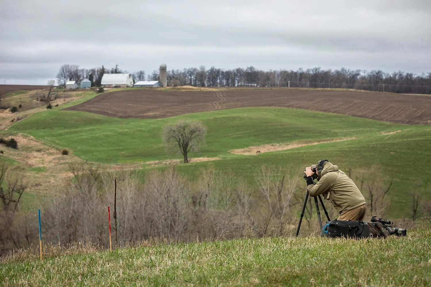 Competitive shooter looks through binoculars