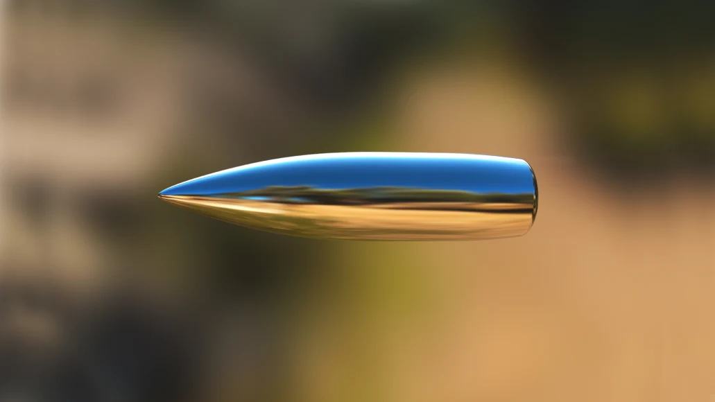 A bullet in flight with a blurred background.