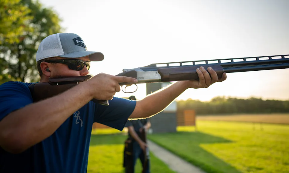 A man shoots a Browning Citori Trap shotgun on a range.