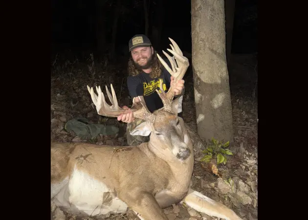 A hunter poses with a trophy-class whitetail taken in Ohio. 