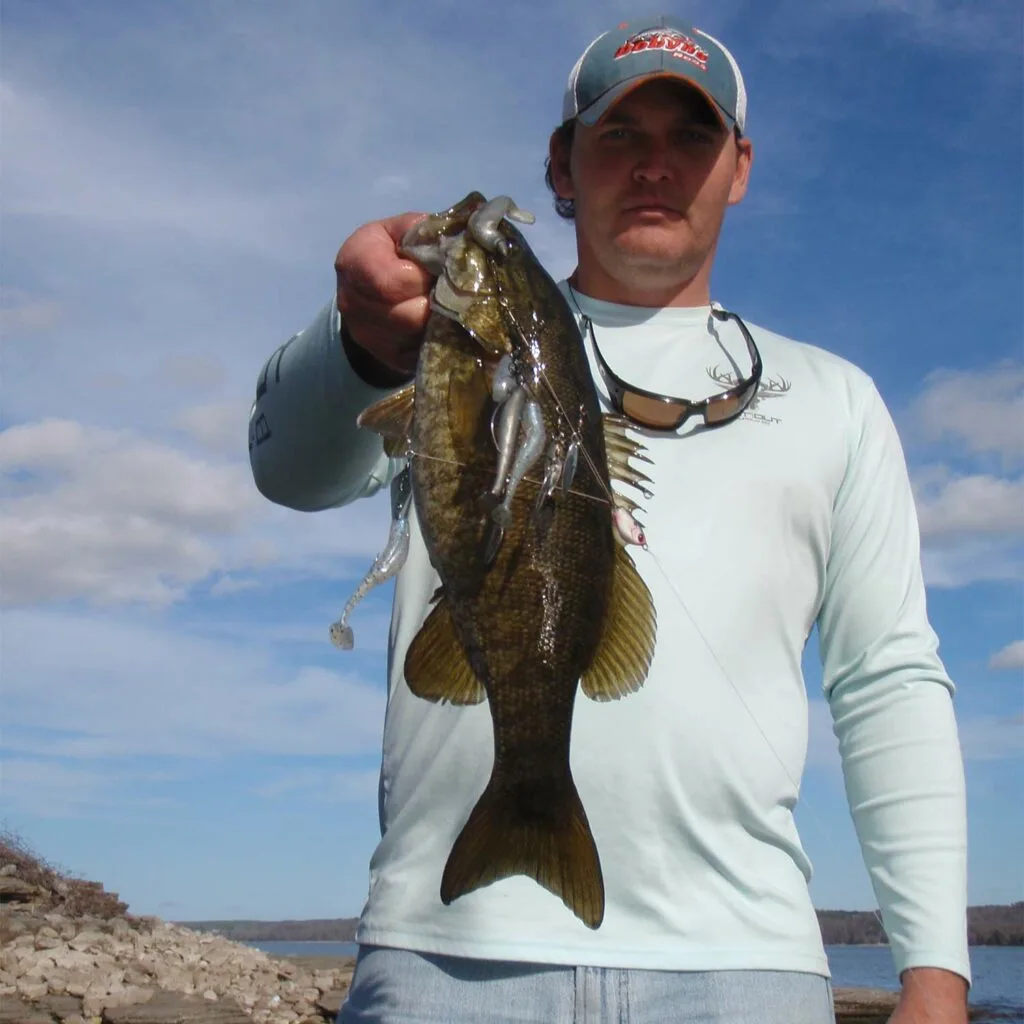 Angler holding up a largemouth bass.