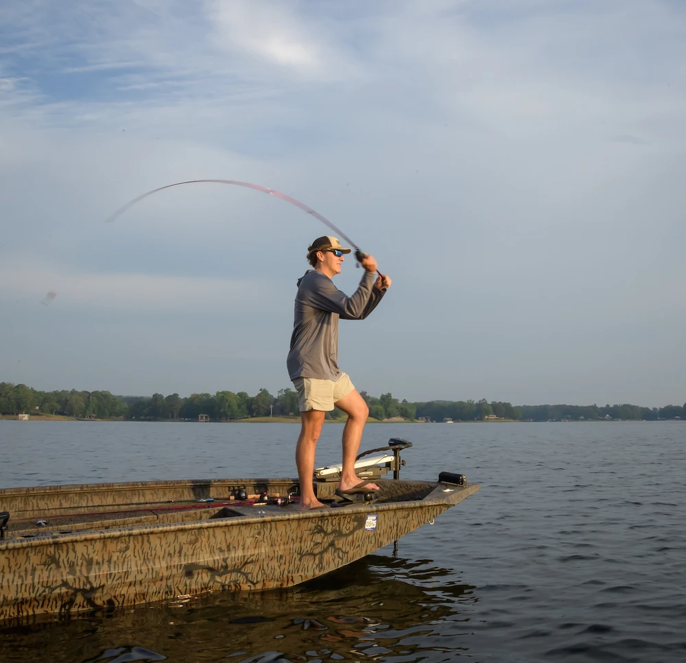 Angler using Ugly Stik casting rod on boat