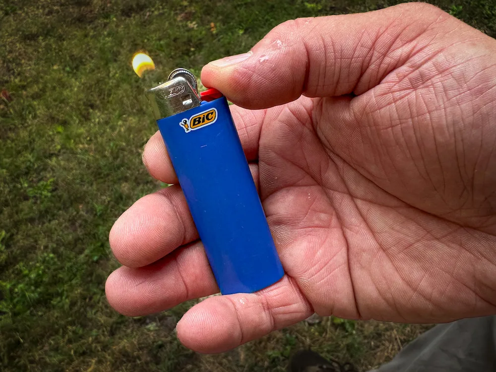 Close-up of man's hand lighting BIC Classic Lighter