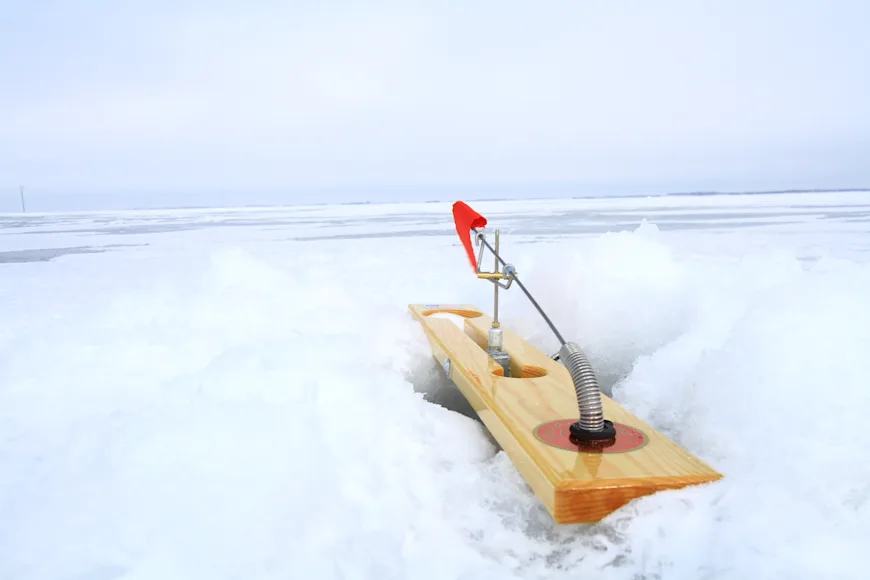Tip-up fishing rig over ice hole