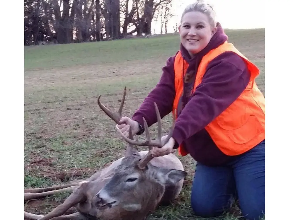 deer hunter with an antlered doe