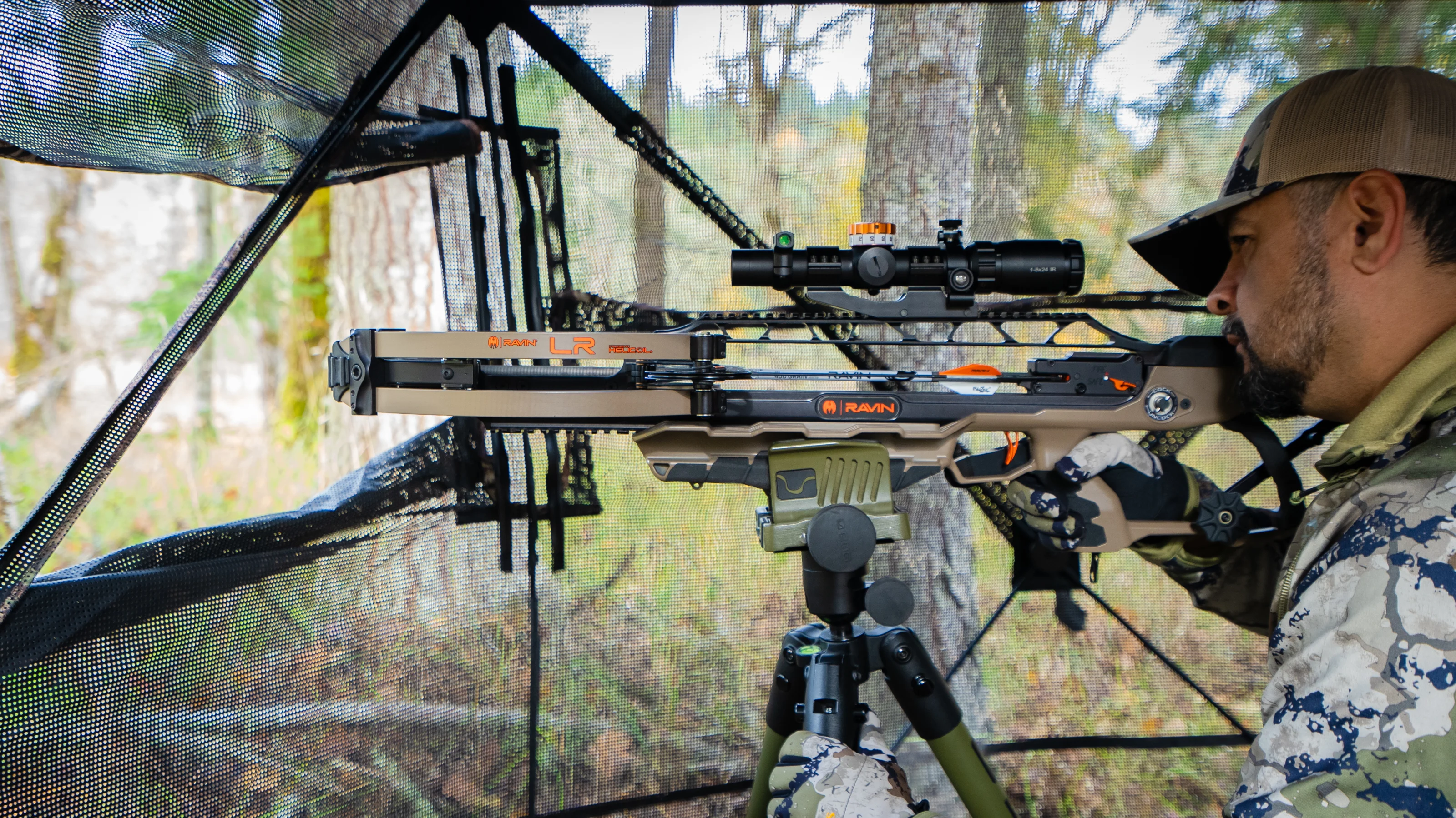 A hunter shoots the Ravin LR crossbow from a ground blind. 