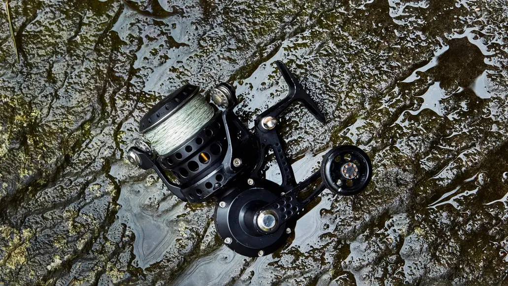 spinning reel lying on wet rock