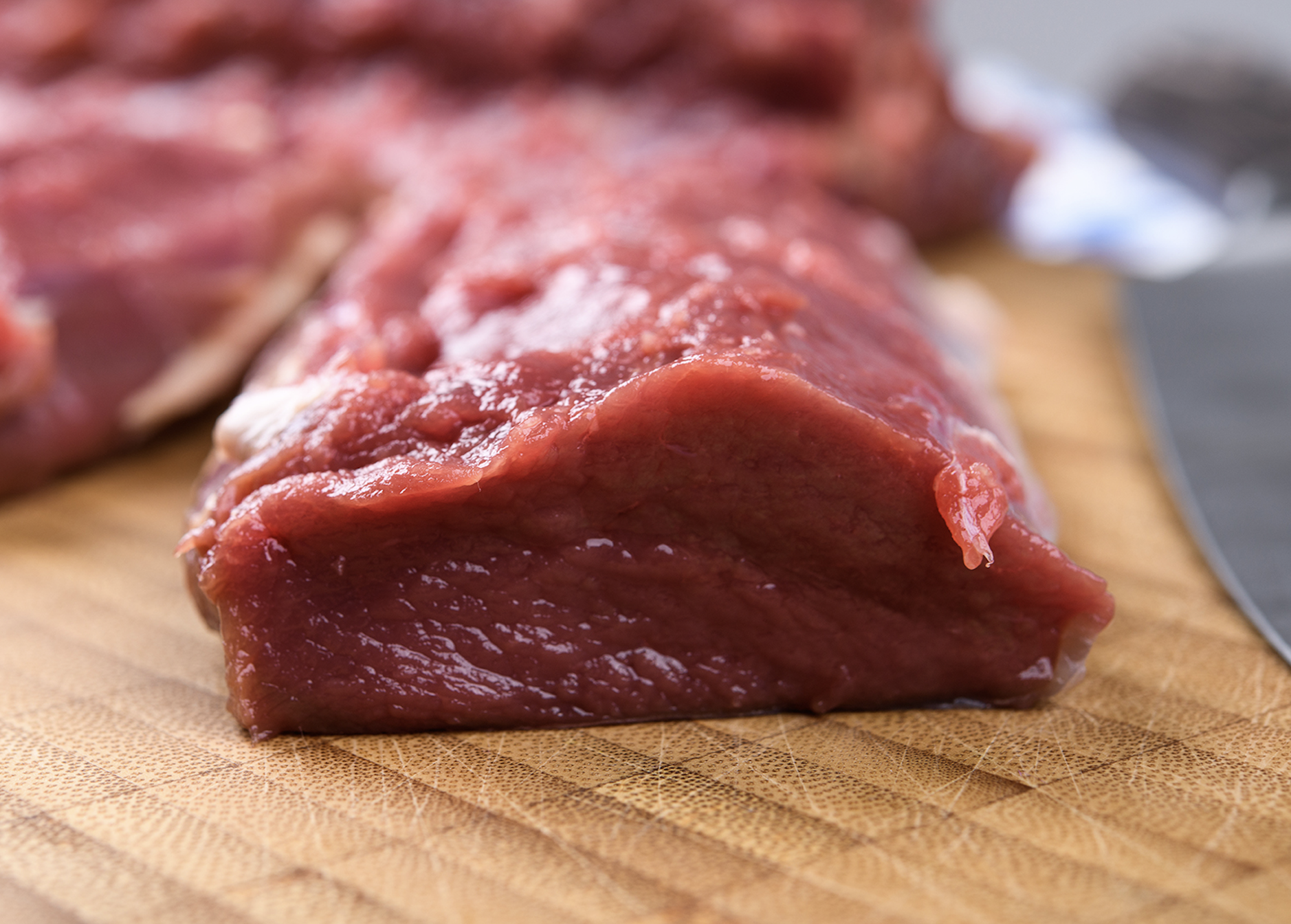 Venison backstrap on a cutting board. 
