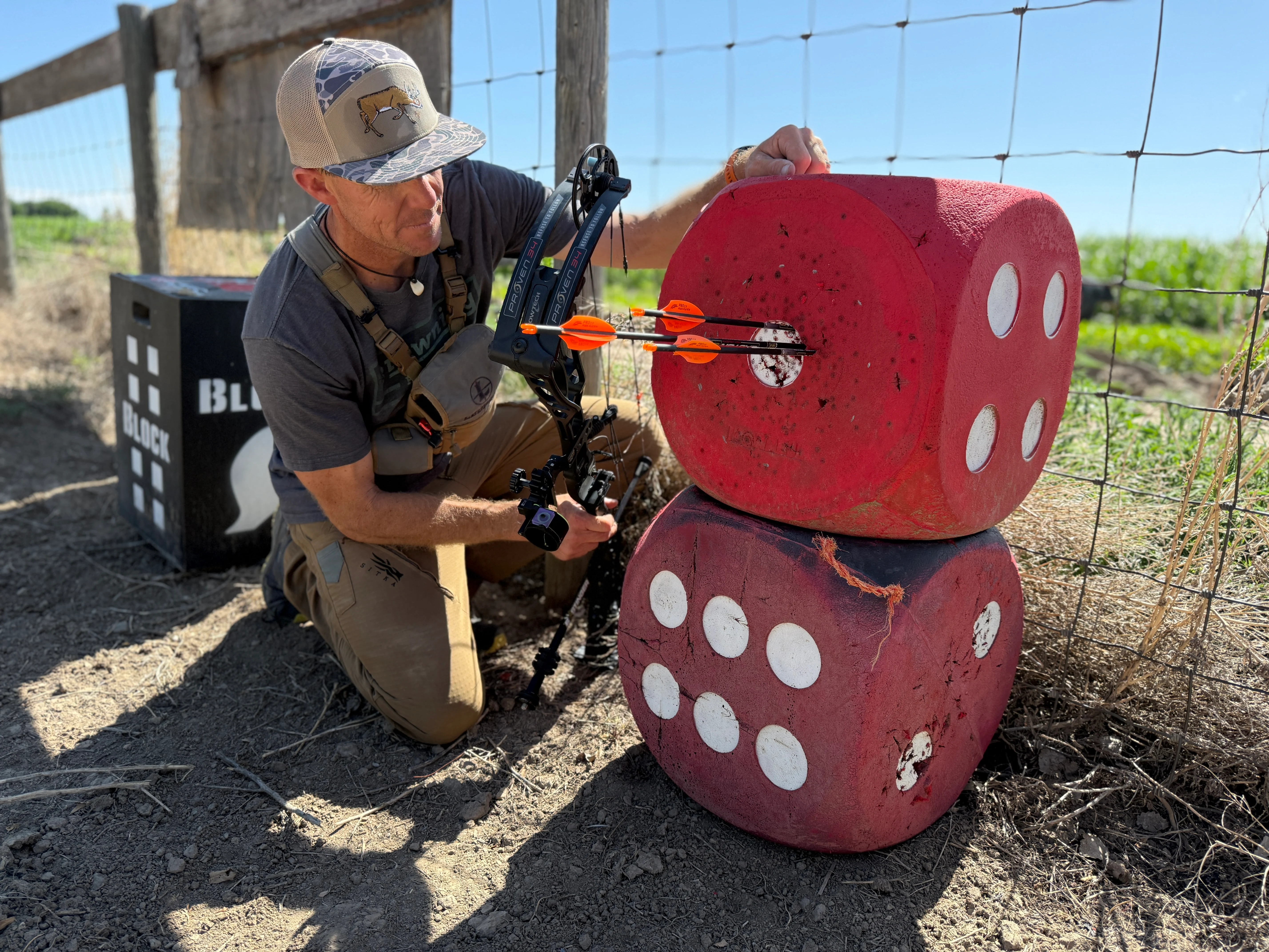 An archer pulls arrows from a Morrel High Roller foam archery target. 