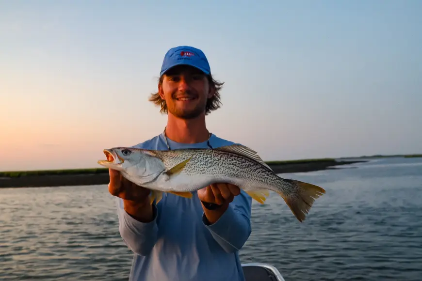 fisherman holding speckled trout