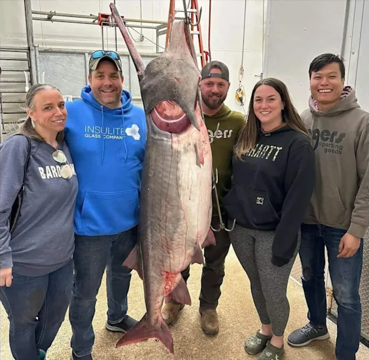 A group of anglers pose with a record-breaking paddlefish in Missouri.