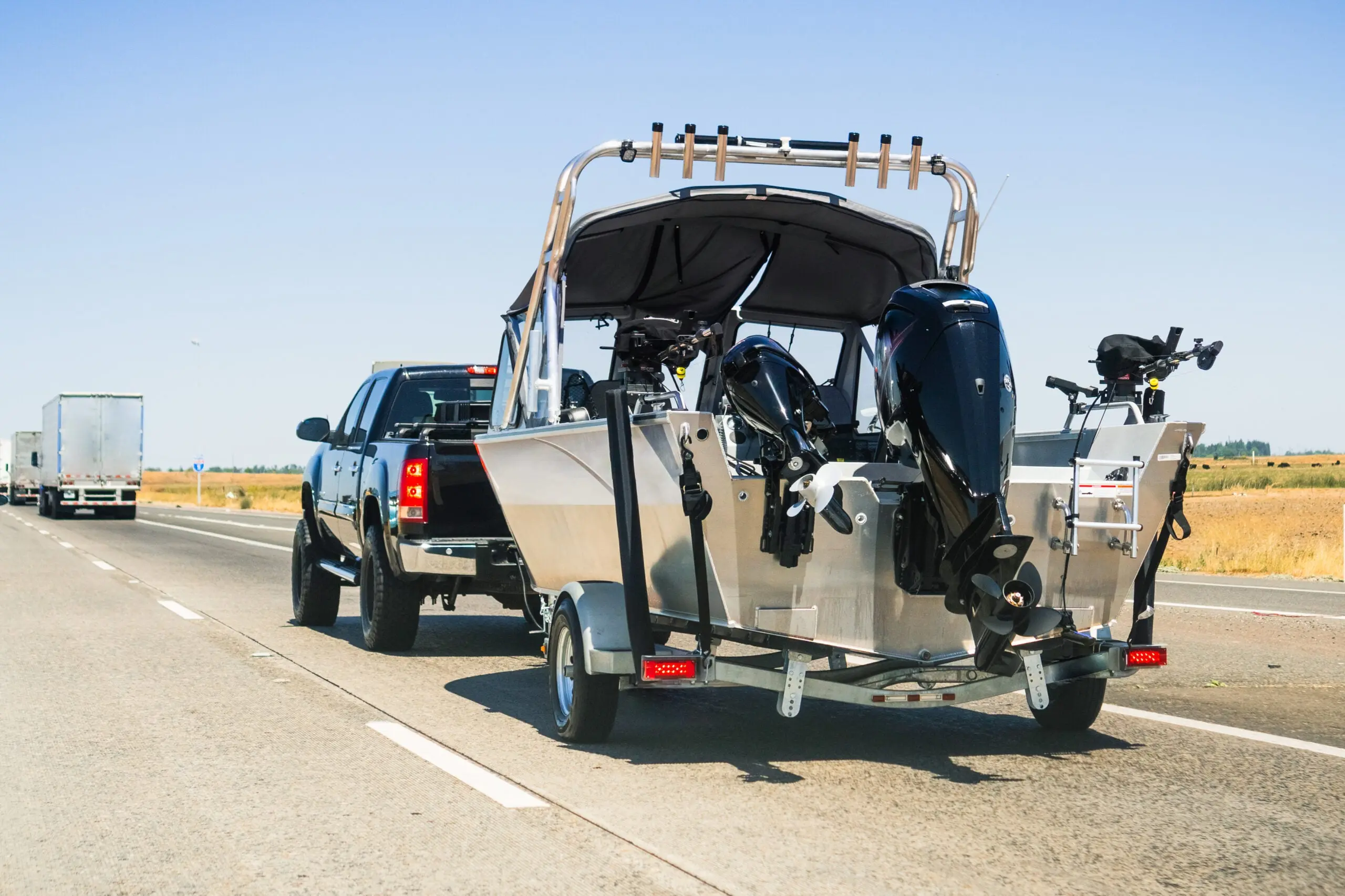 Pickup truck towing a boat on the highway