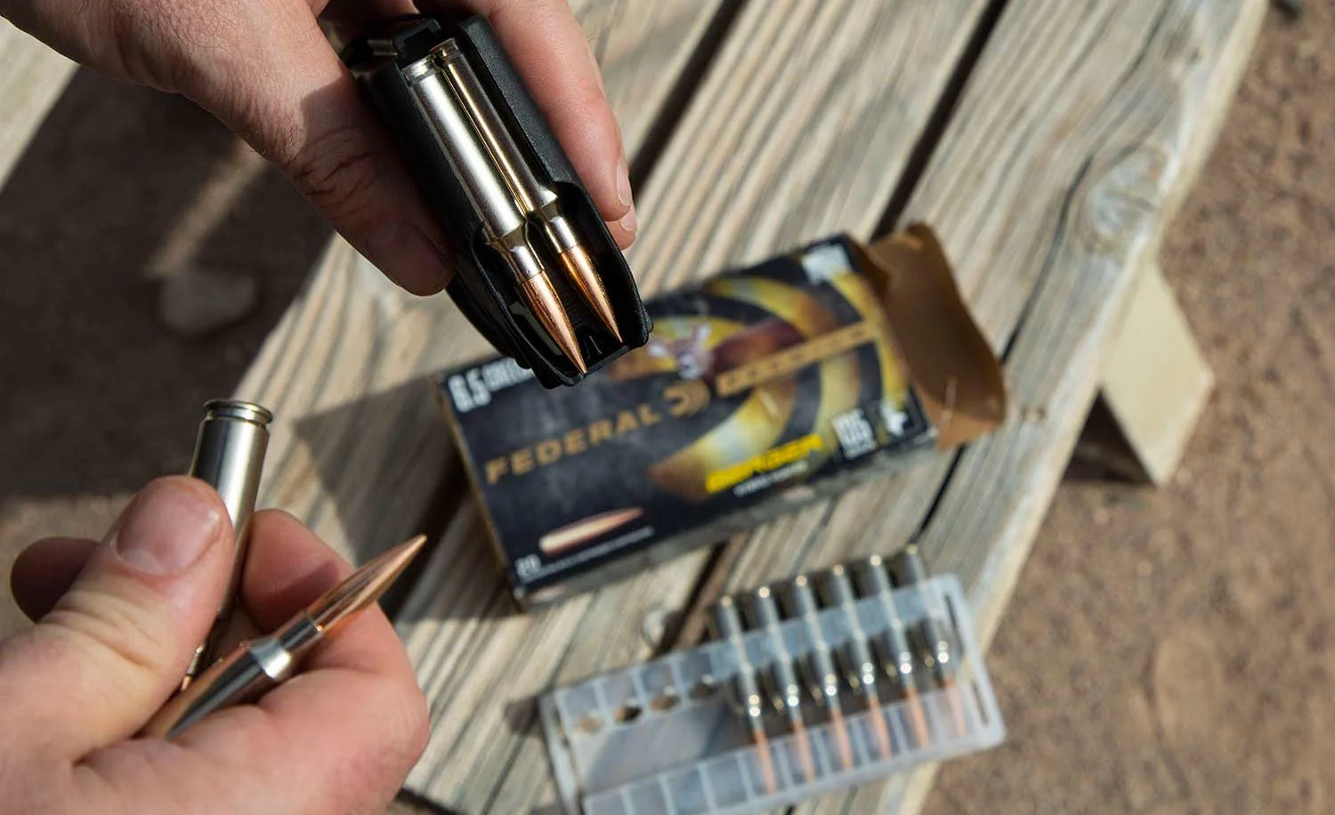 Hand loading 6.5 Creedmoor ammo into a magazine.