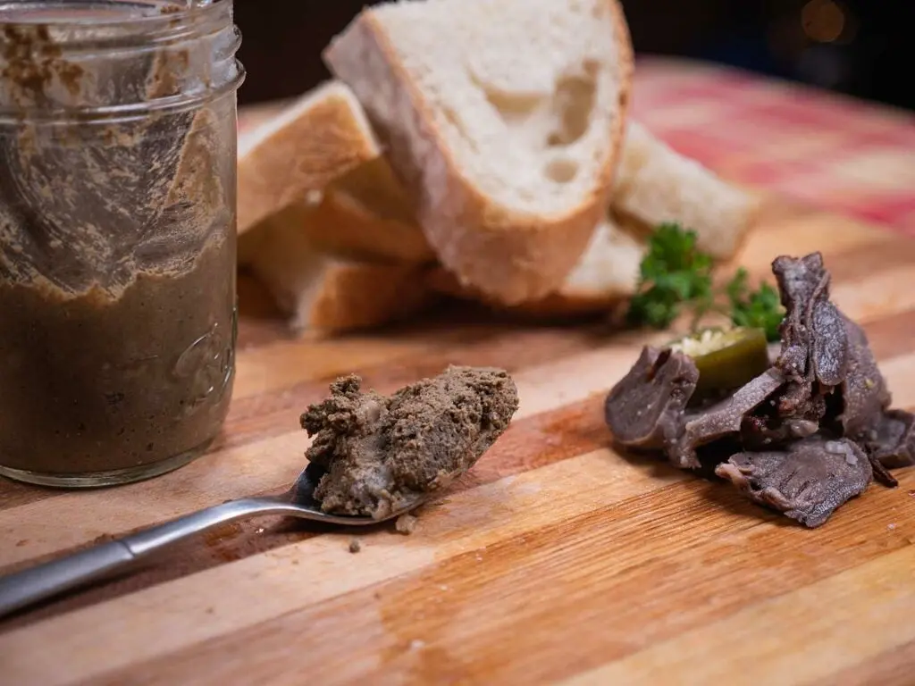 venison liver pate on a wooden cutting board.