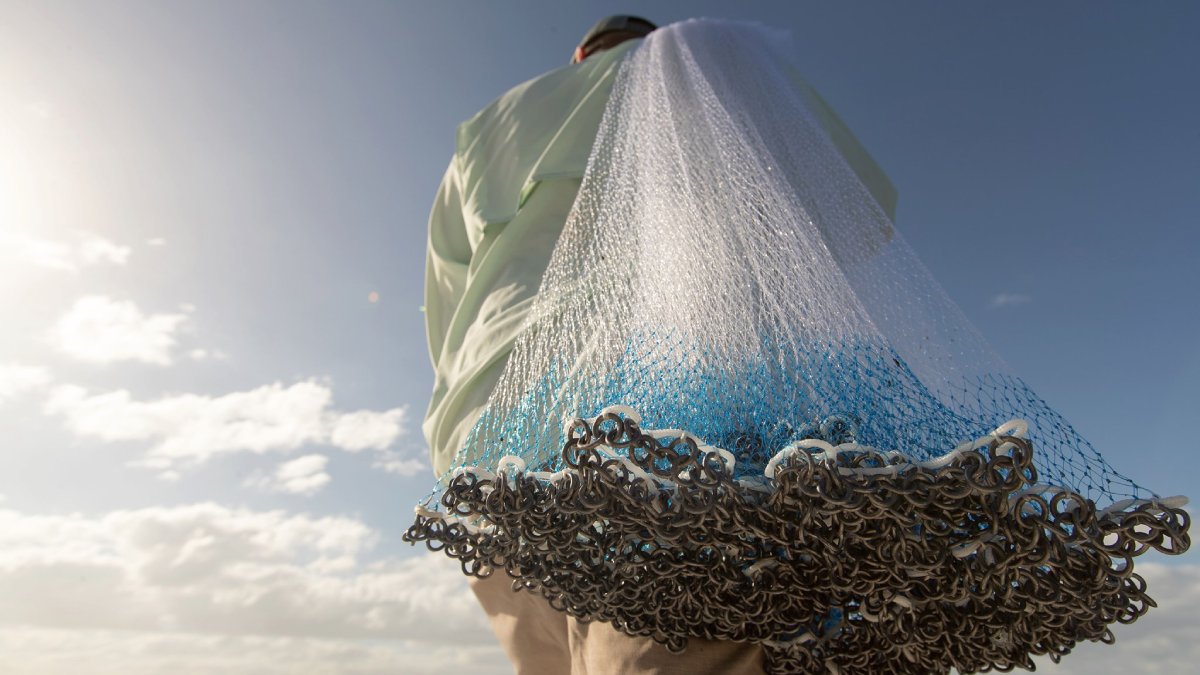 Angler holding cast net over shoulder