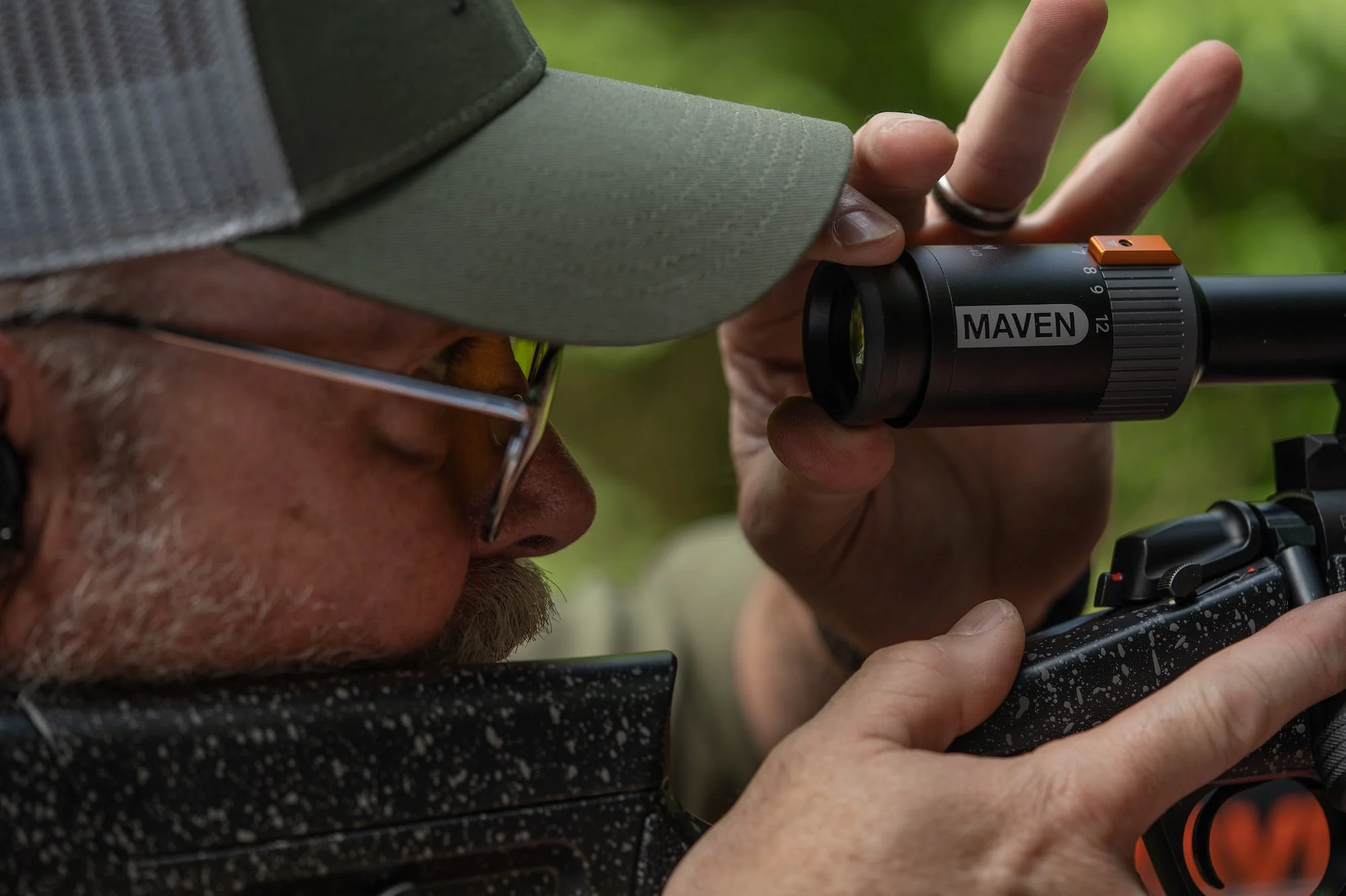 Man adjusting the diopter of a rifle scope.