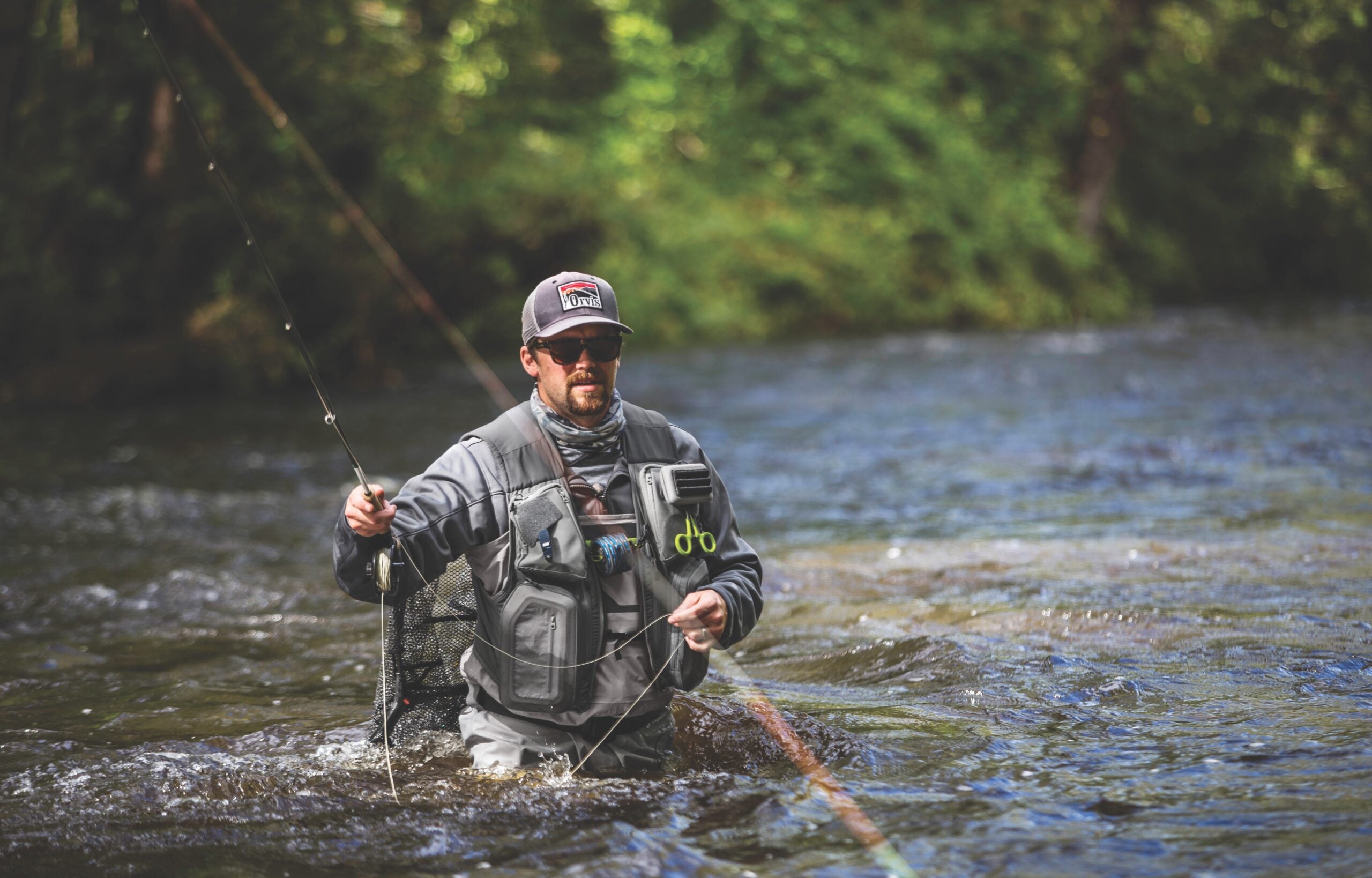 man fly fishing in river