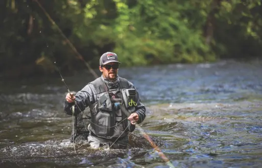 man fly fishing in river