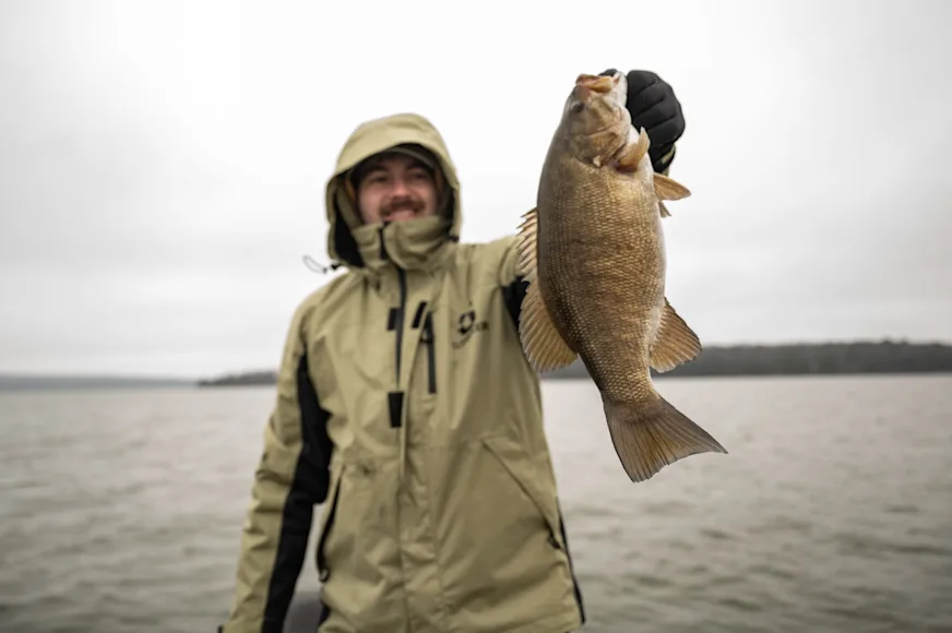 Angler holds up smallmouth bass