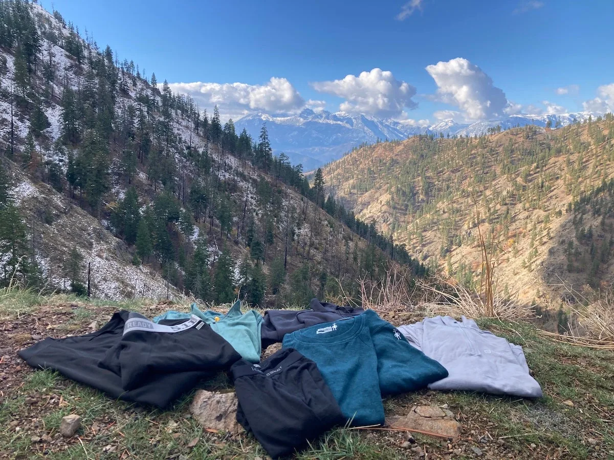 Assorted long johns and base layers spread out on mountain overlook