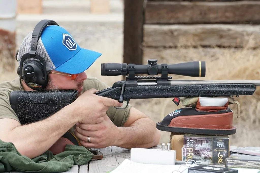 man aiming a hunting rifle