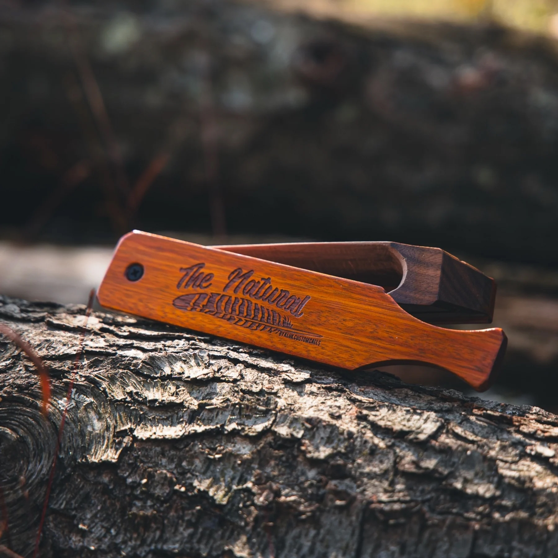 Kluck Custom Calls The Natural box call sits on a log. 