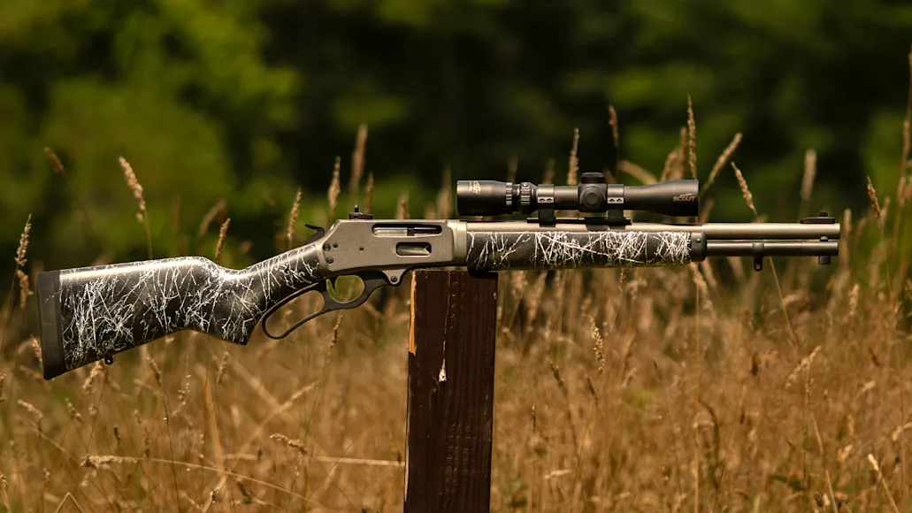 Dove Custom Appalachian Scout Marlin 336 carbine sitting on a post in a field.