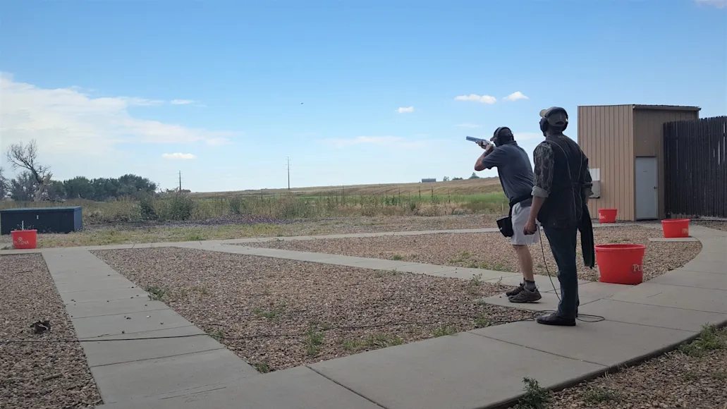 trap vs skeet: a shooter lines up to shoot skeet.