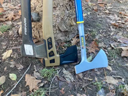 Heads of camping axes lined up on ground