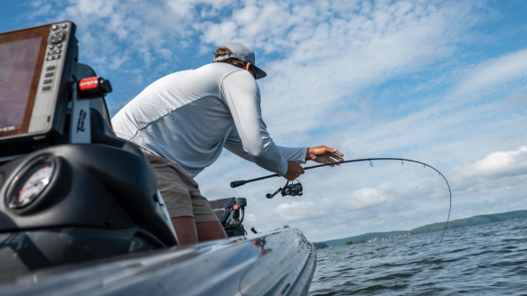 Angler bass fishing from boat with Abu Garcia fishing rod