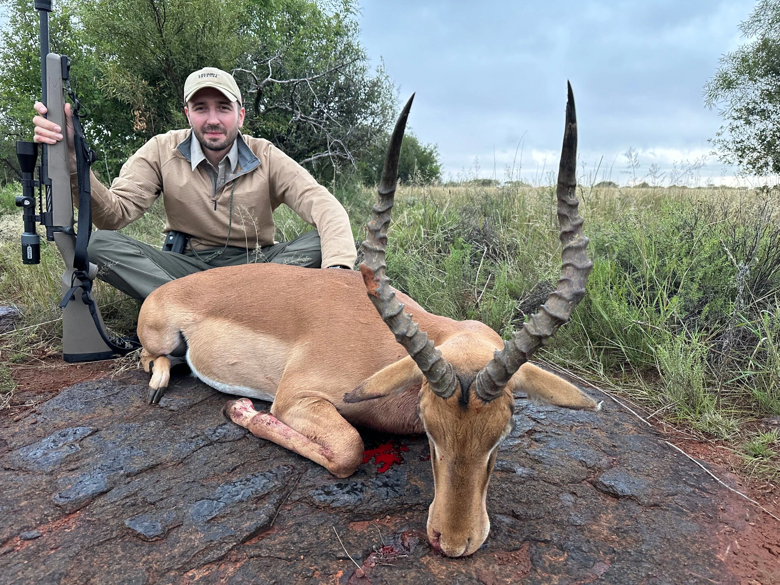 A hunter in Africa with an impala taken Lehigh Defense Xtreme Chaos ammo.