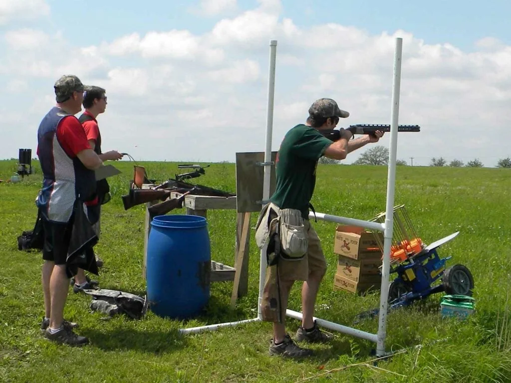 A group of people at a shooting range.