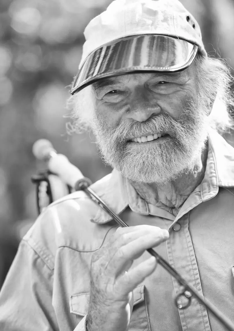 Portrait of outdoor personality Flip Palot, with a saltwater fly rod over his shoulder.