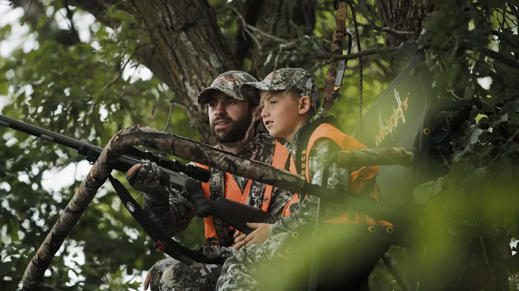 Father and son hunting in Muddy Treestand