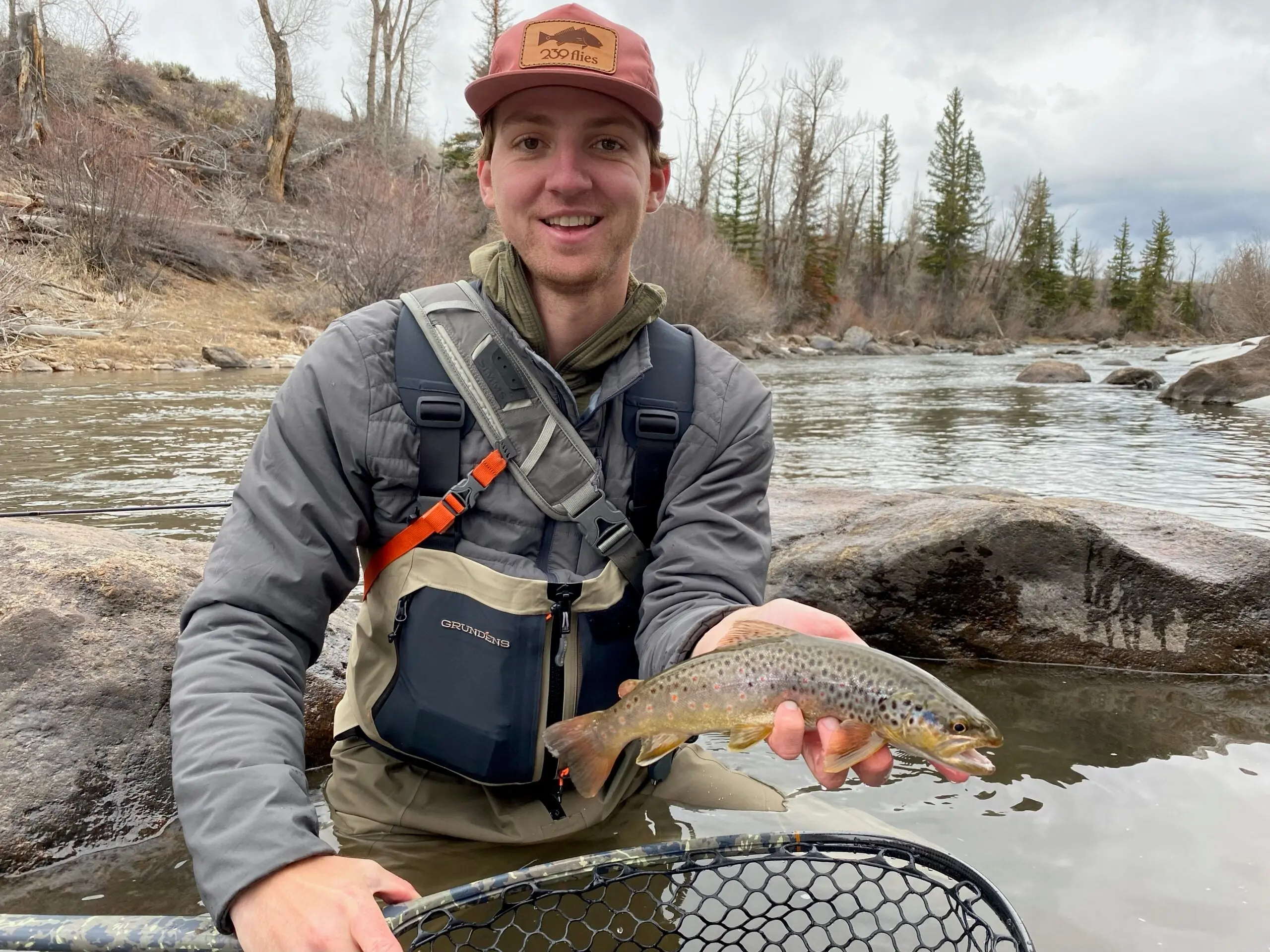 Chelius holds up a brown trout in his Grunden's Boundary waders.